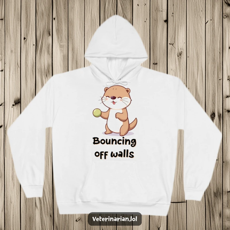 Funny playful otter hoodie showing an otter bouncing a ball for an unseen patient, exuding gentle care and amusement.