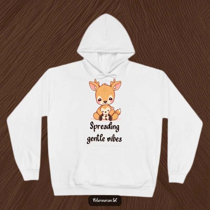 Funny gentle deer hoodie showing a deer cradling a small animal with a loving pat and a peaceful expression.